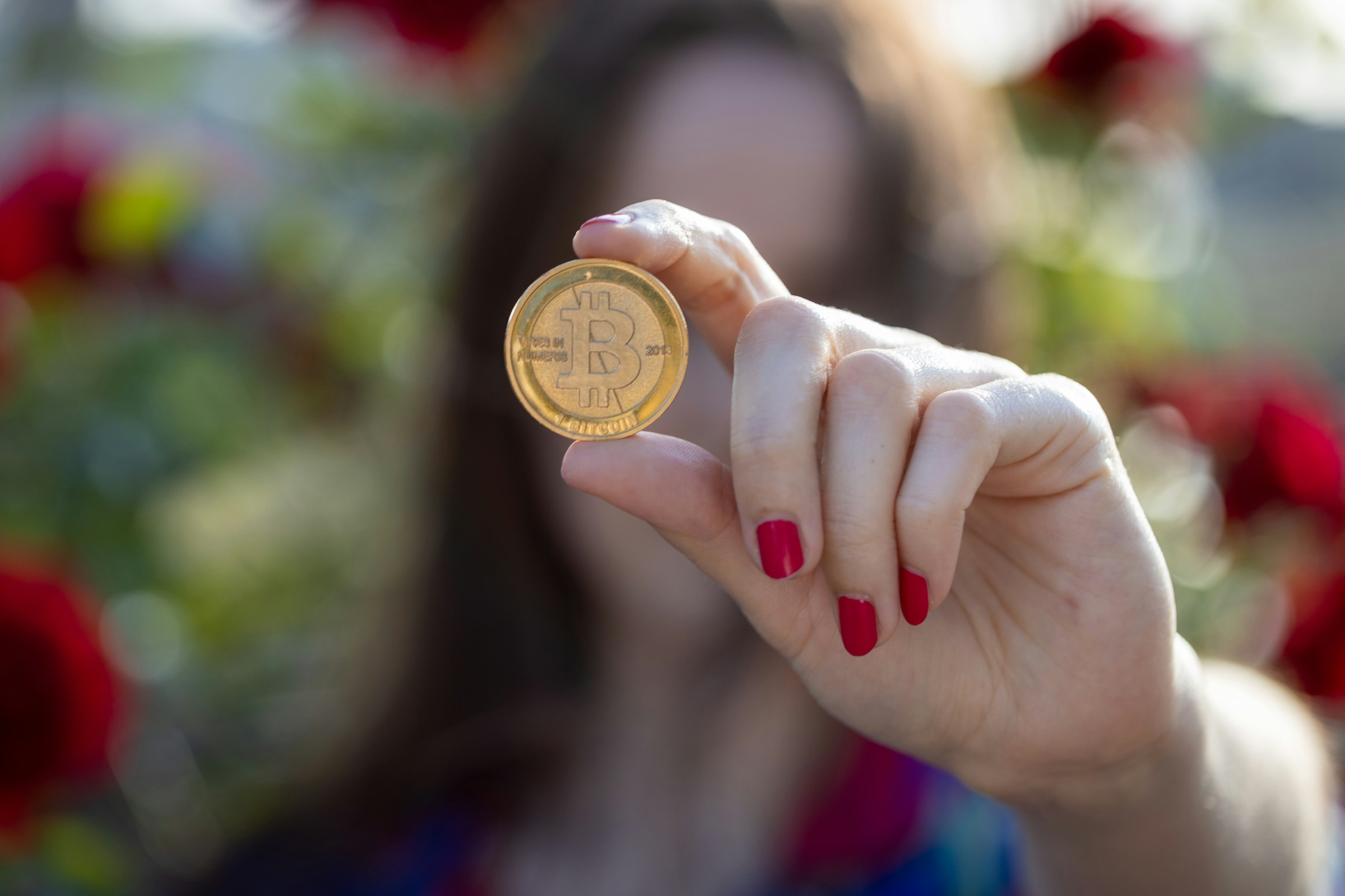 Lady Holding Bit Coin - Prop Firm Reviews