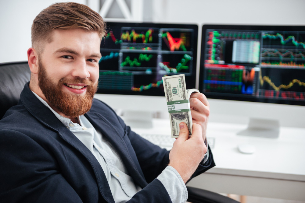 man smiling and holding dollar bills - Why Do Most Day Traders Fail