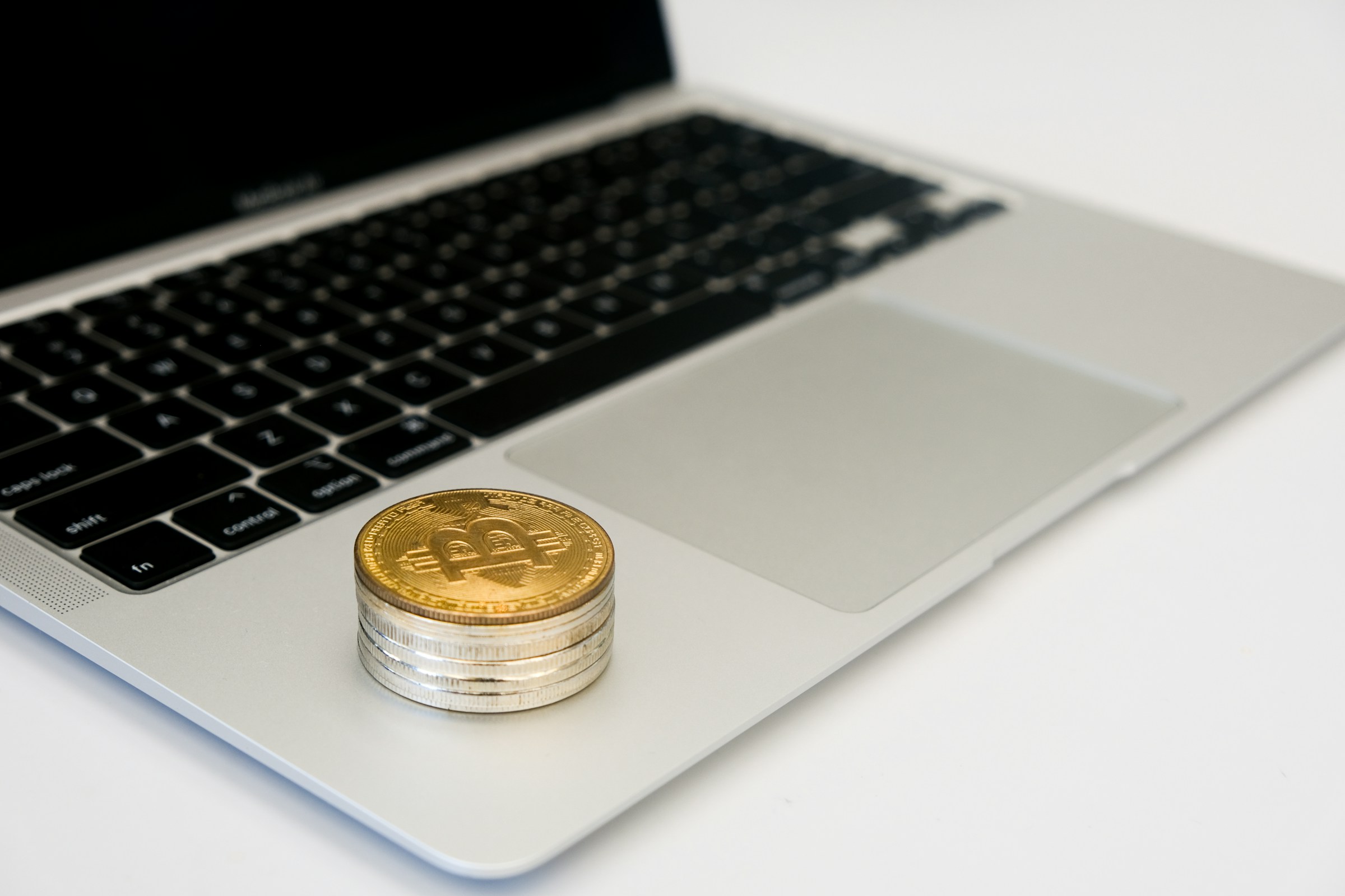 Coins Laying on Laptop - How Do Prop Firms Make Money