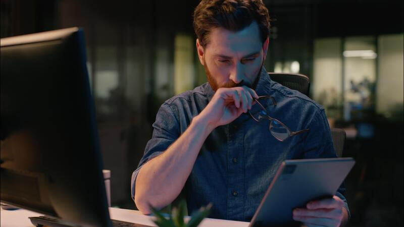man looking at a tablet - What is Risk Management in Trading