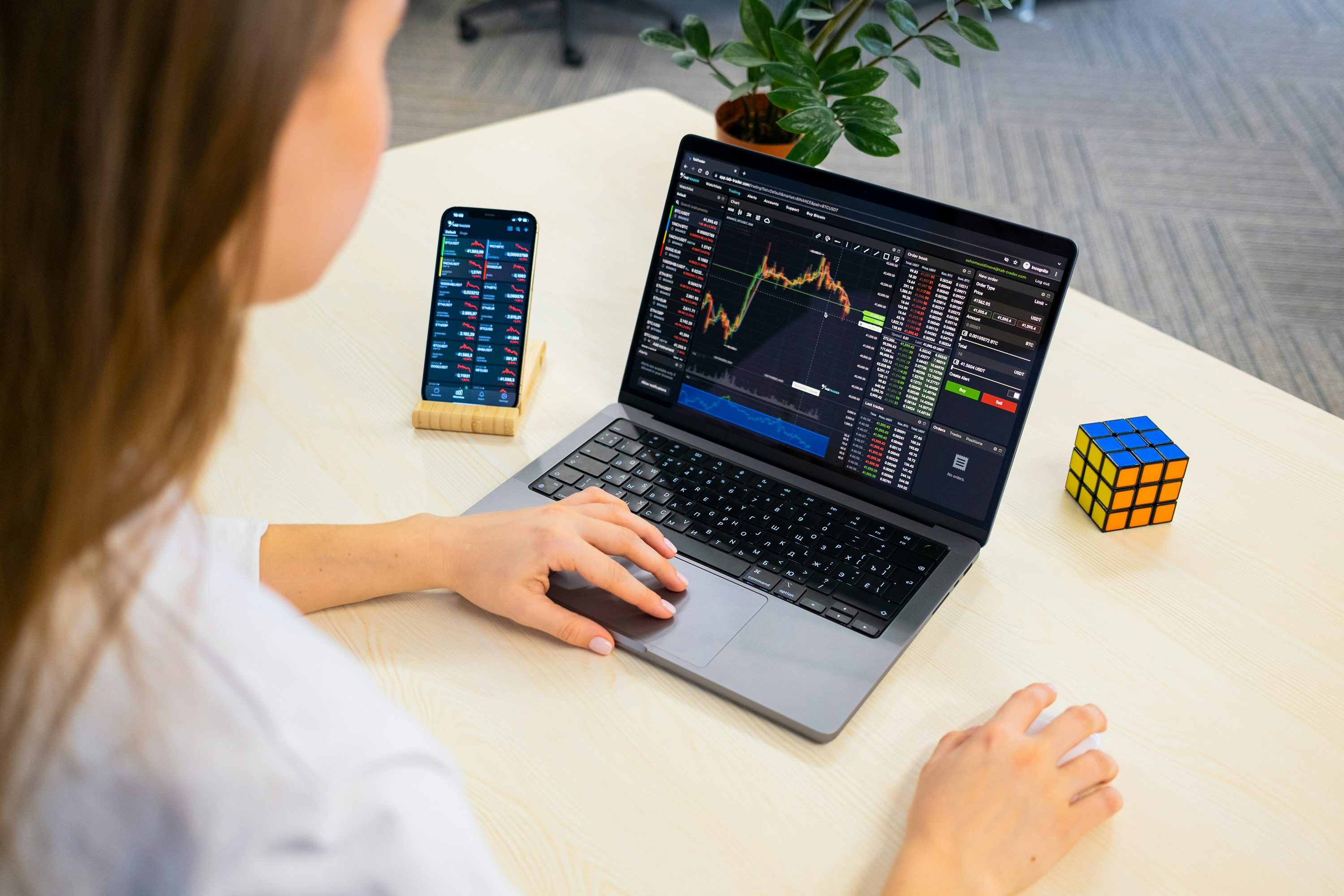 a woman sitting at a table using a laptop computer - Volatility Indicator MT4