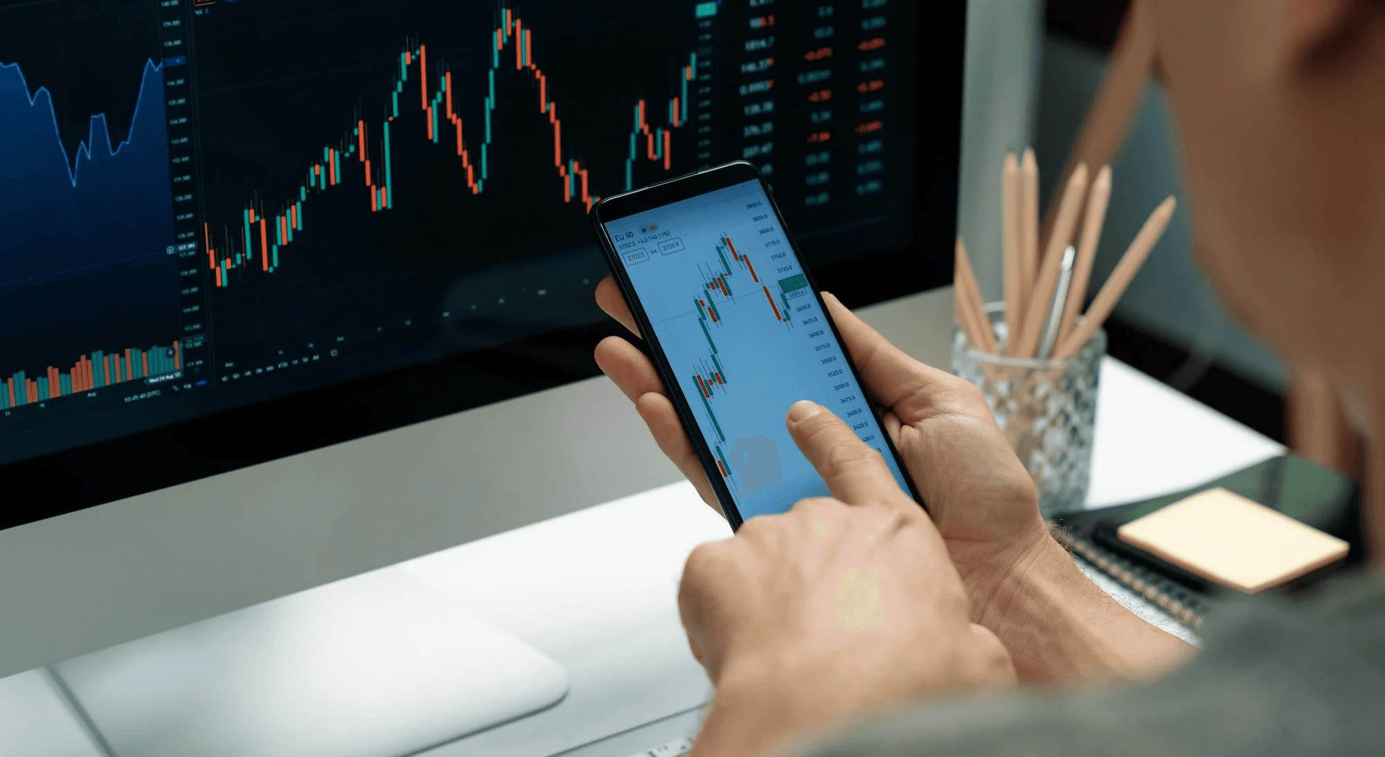 Man tracking stocks on multiple devices - Forex Trading Profit Per Day