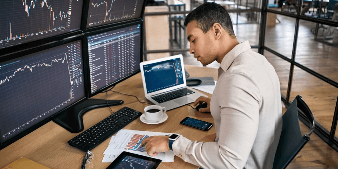 Person monitoring stock market trading charts - Best Charting Software for Day Trading