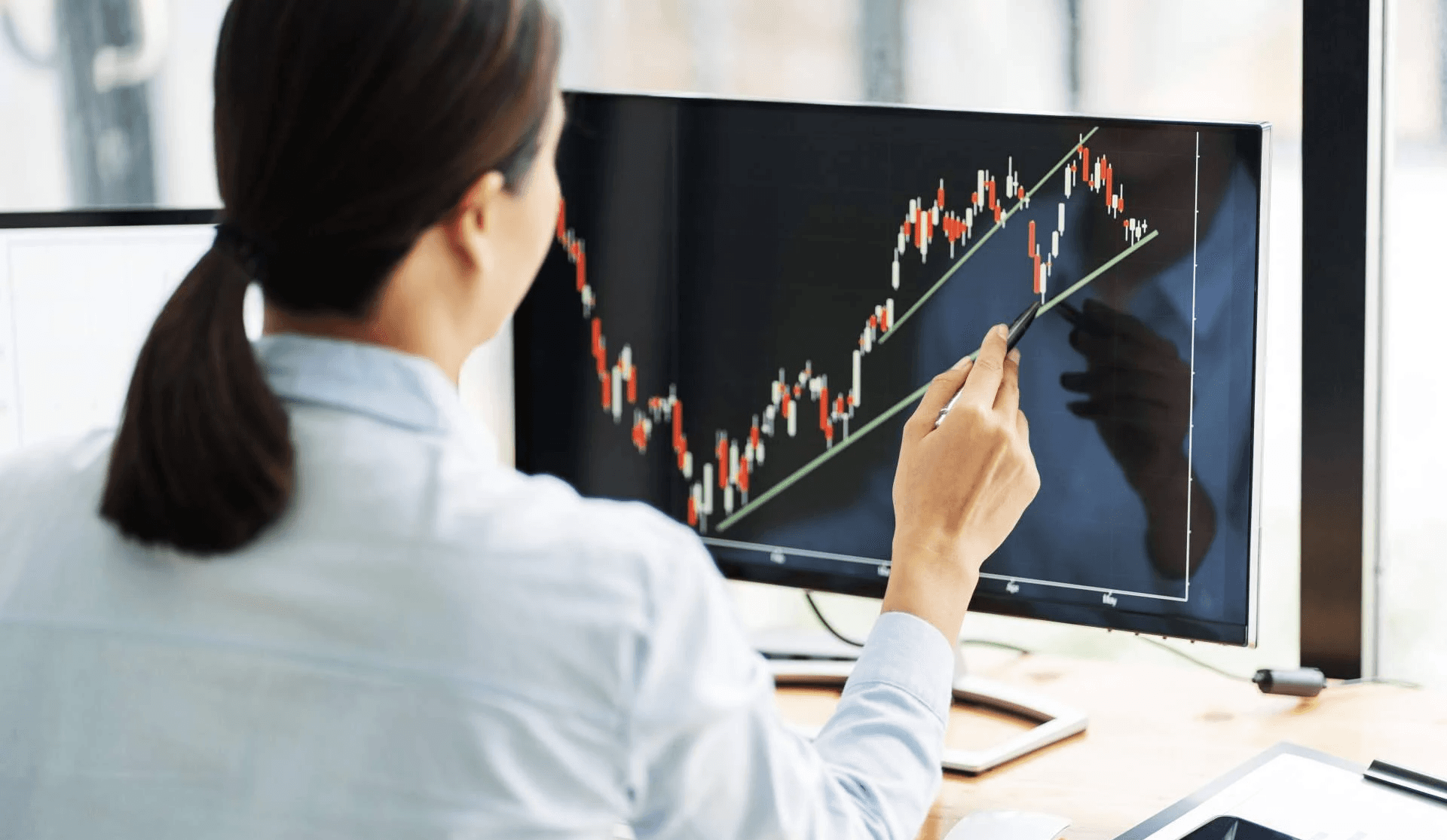 Woman analyzing stock market chart -  Fair Value Gap Trading Strategy