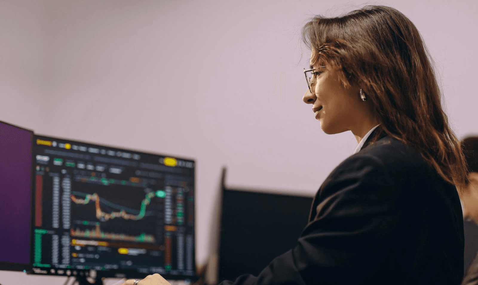 Woman monitoring financial charts - Best Copy Trading Platform
