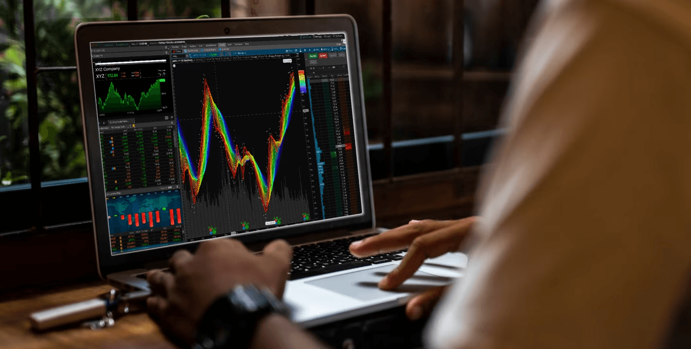 Laptop displaying colorful financial trading charts - Futures Trading For Beginners