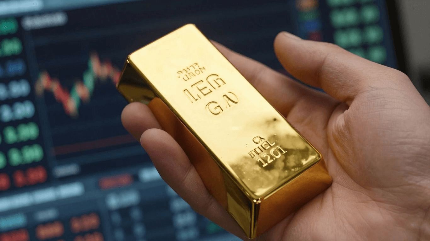 Gold bar held before trading chart -  Trading Gold Futures