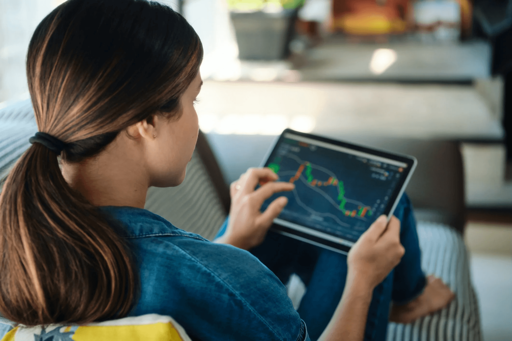Woman tracking stock charts on tablet - Isolated vs Cross Margin