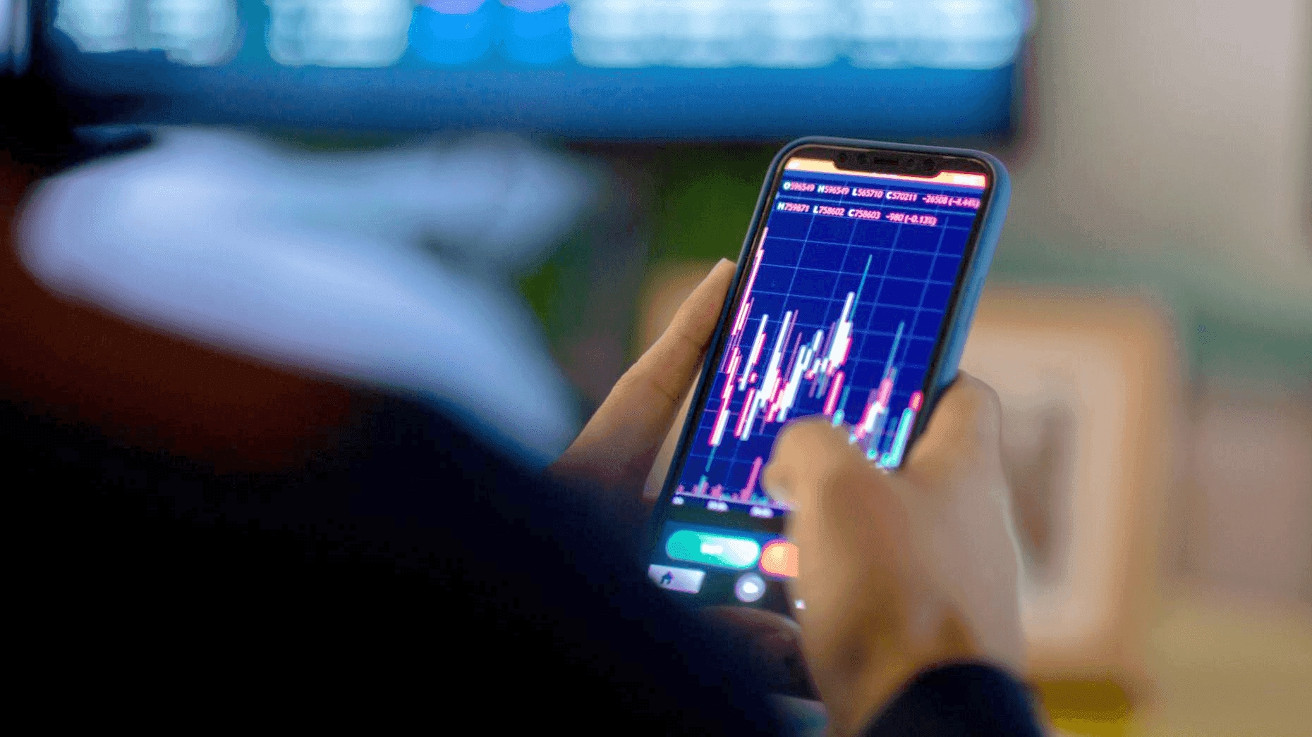 Person analyzes candlestick charts on mobile - Intraday Margin Futures