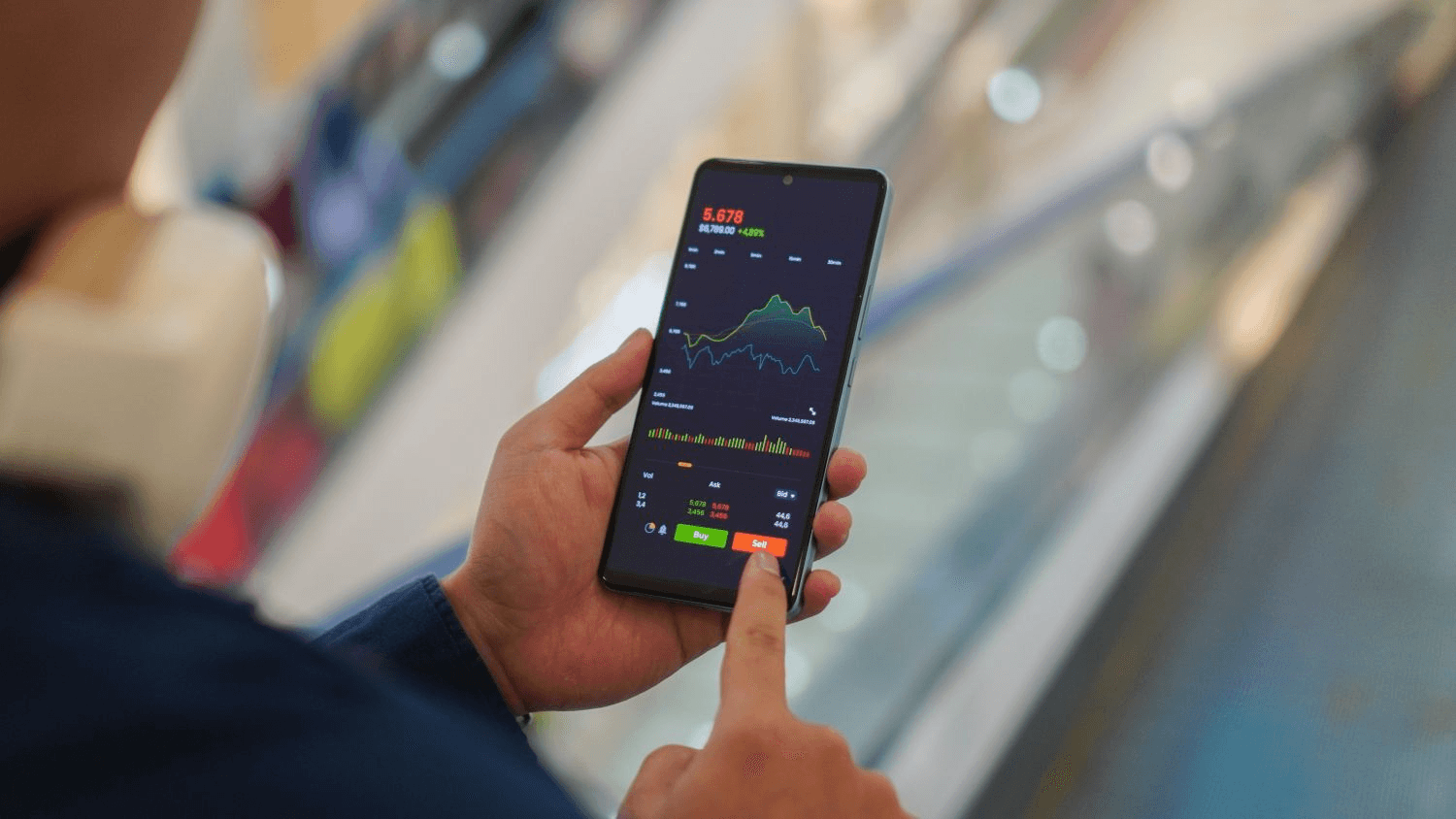 Man trades stocks via mobile - Futures Brokers With Low Intraday Margin