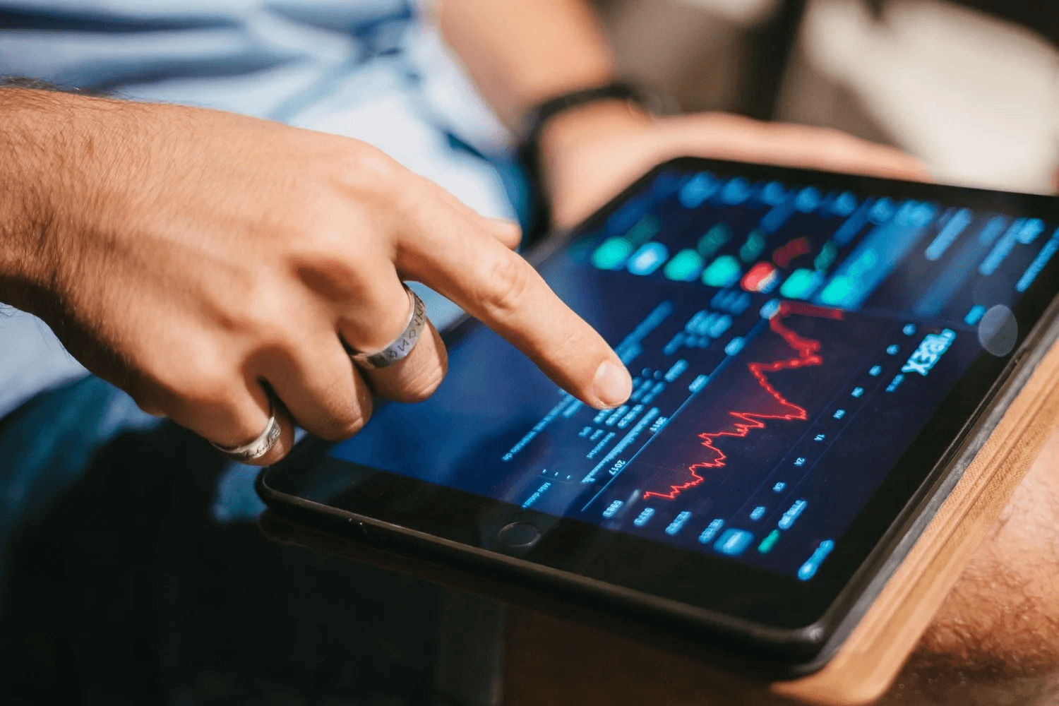 Person analyzes financial charts on tablet - How to Calculate Implicit Interest Rate