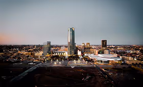City skyline at dusk with illuminated buildings and a stadium in the foreground, highlighting a large metropolitan area with strong healthcare infrastructure.