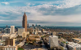 Atlanta, Georgia cityscape with skyscrapers under a cloudy sky, illustrating a major regional hub for healthcare systems and medical staffing.