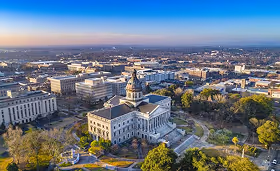 Aerial view of the Tennessee State Capitol in Nashville surrounded by autumn trees at sunset, representing Tennessee’s government center and healthcare market location.