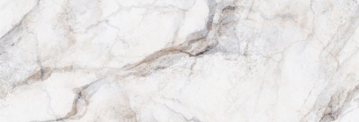 Surface en marbre blanc avec des veines grises et beige claires aux motifs naturels.