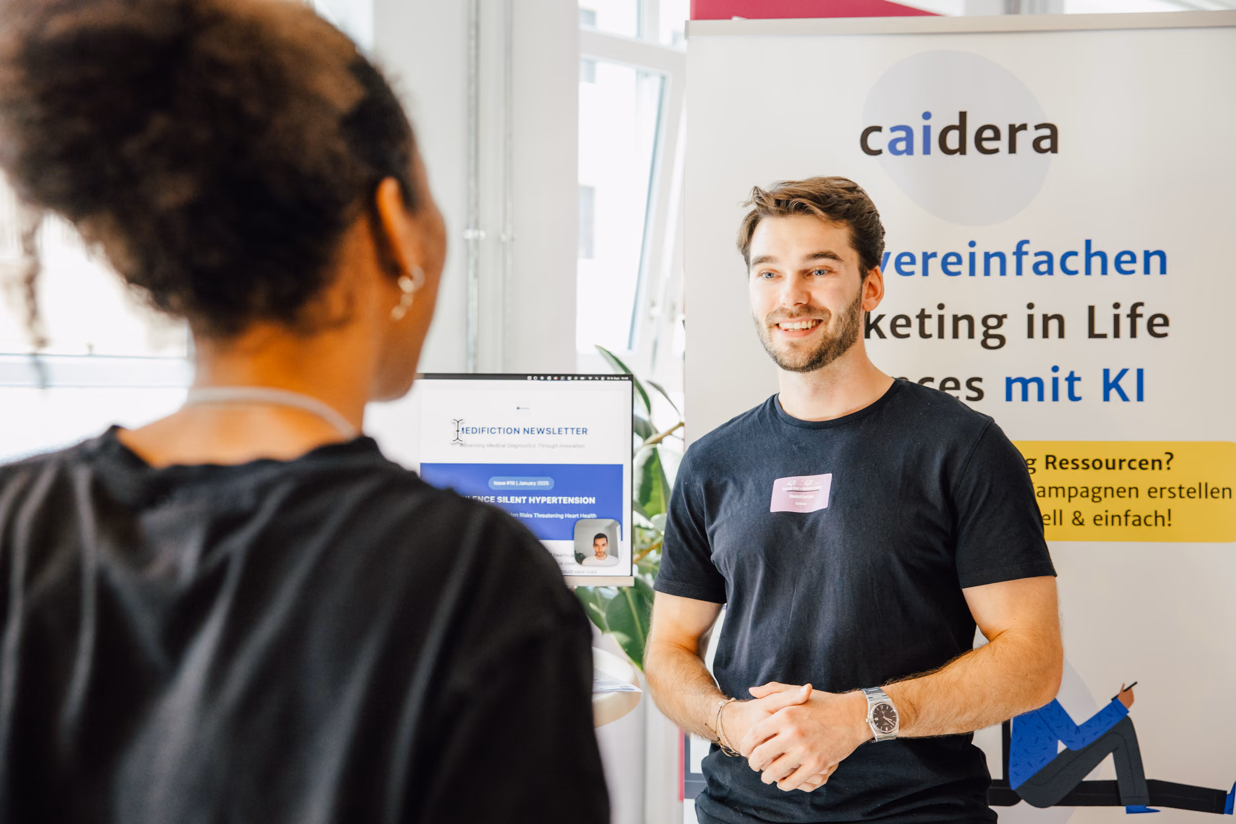 A company representative presenting at a career booth on campus