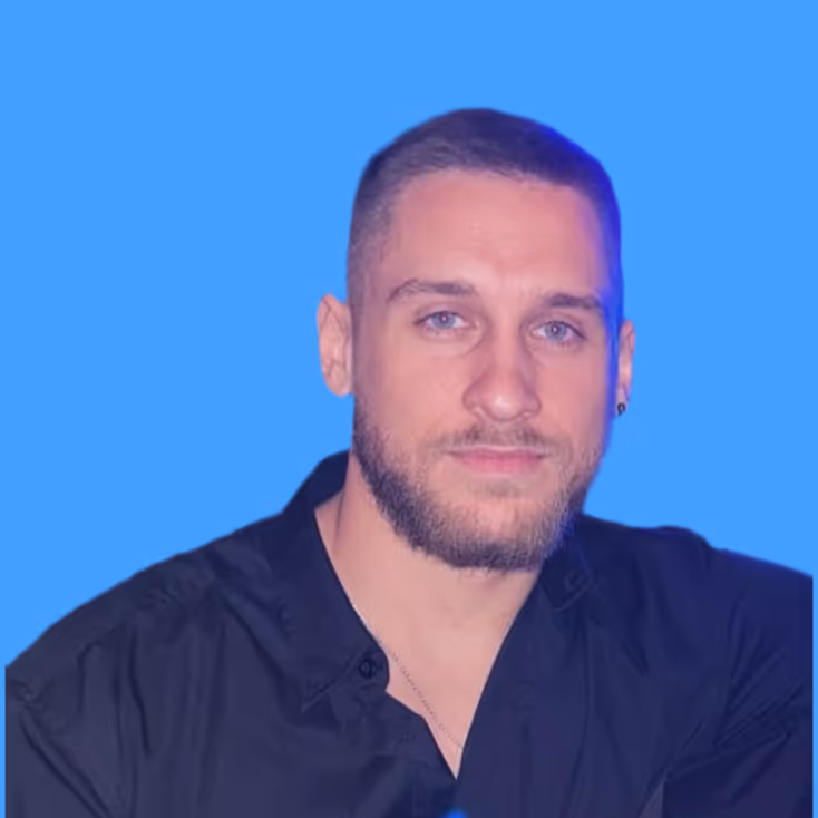 Man with short hair and beard wearing a black shirt against a bright blue background.