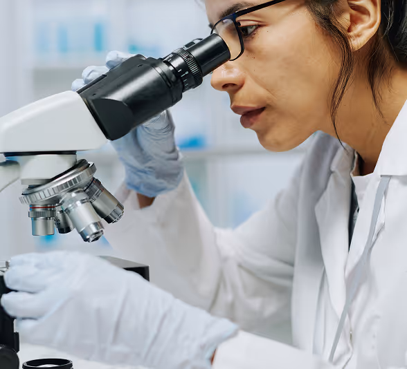 Scientist looking through a microscope in a laboratory