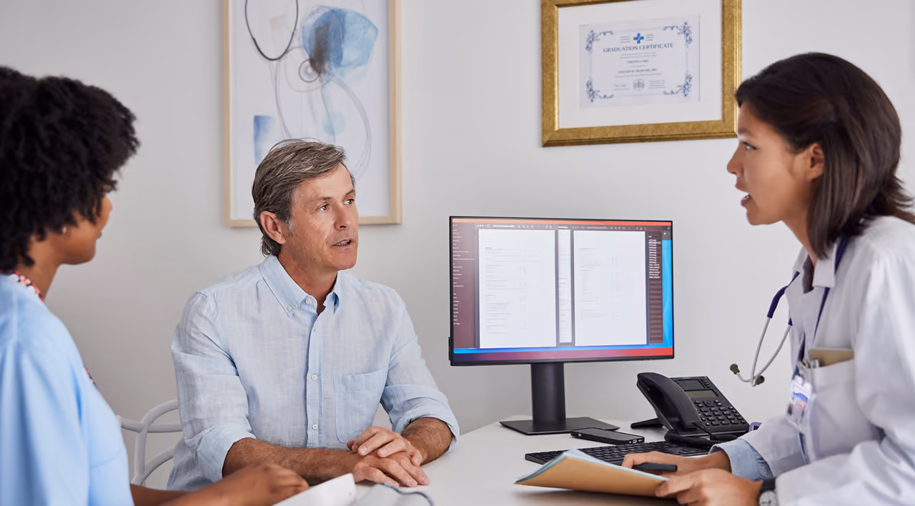 A patient and caregiver discuss treatment and care options with a physician.
