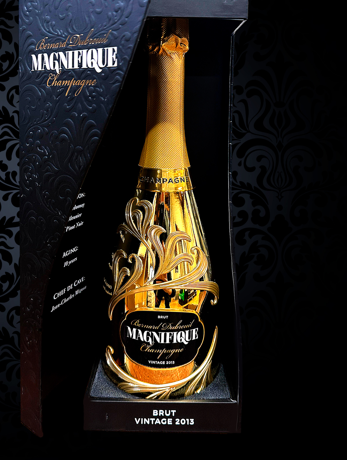 Hand holding a shiny gold bottle of Bernard Dubreuil Magnifique Brut Champagne vintage 2013 with decorative embossed design.