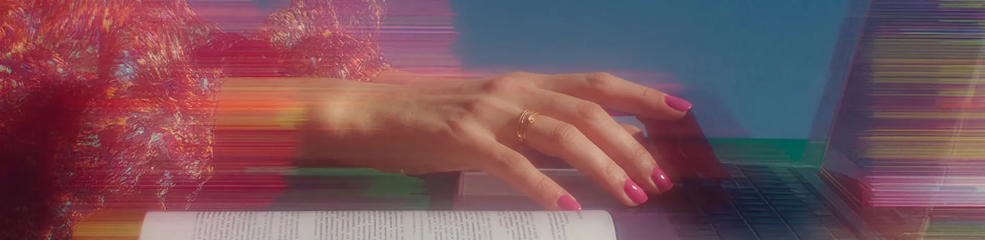 Woman in patterned suit floating while typing on a laptop, with digital code projected behind her on a pink background.