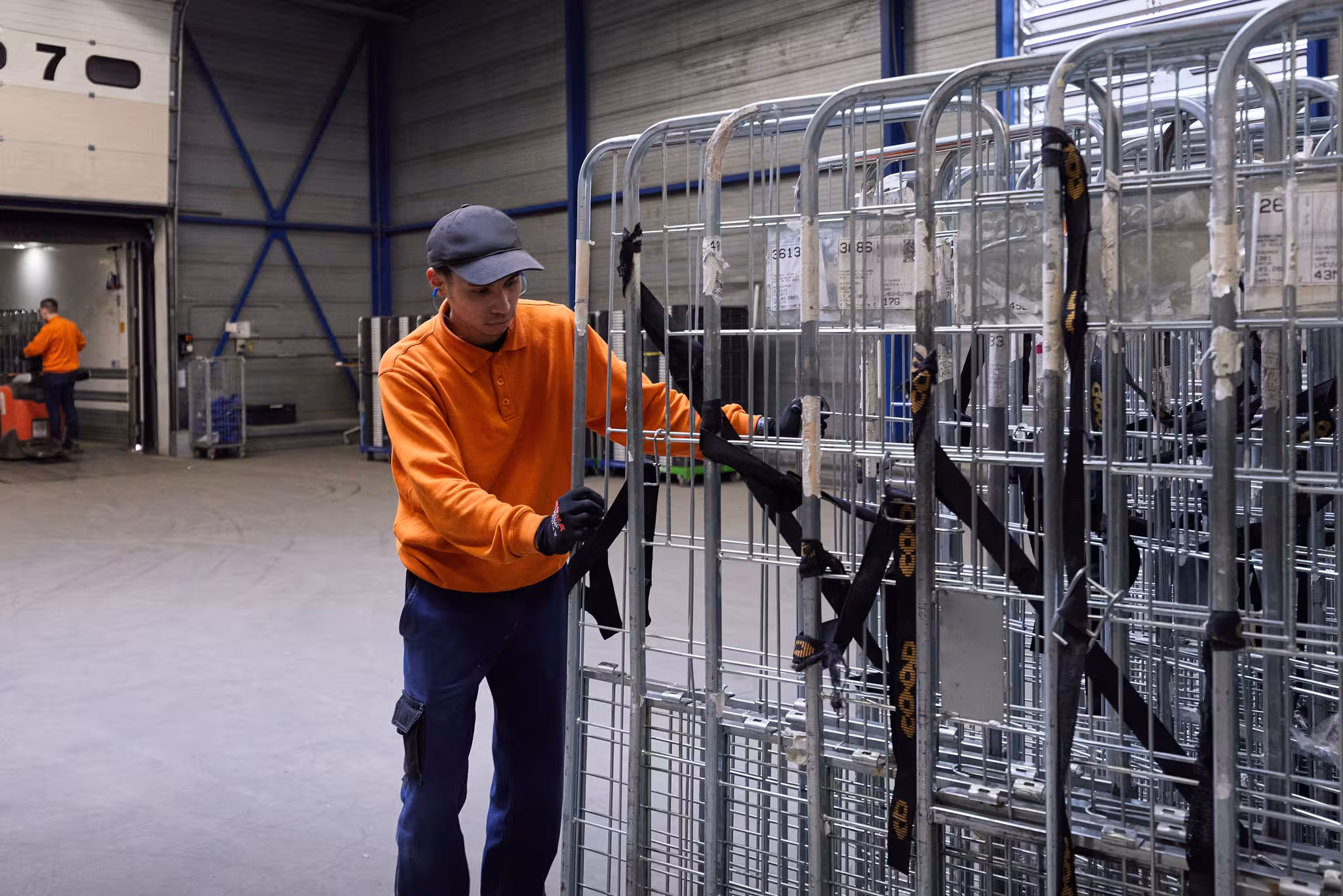 Man rolling metal crates
