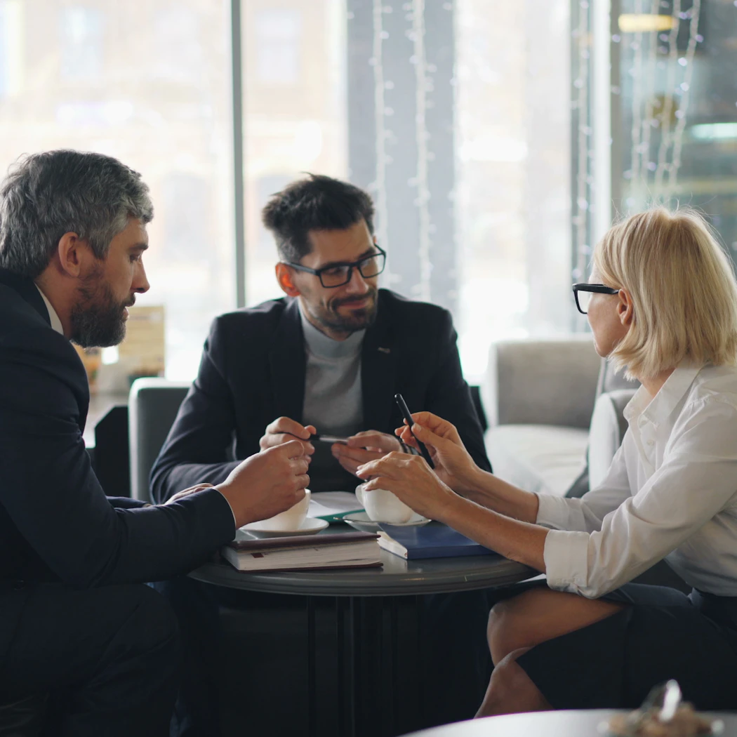Business leaders discussing policy around a conference table