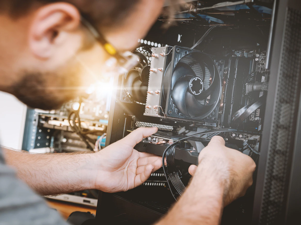 Technician working inside computer hardware