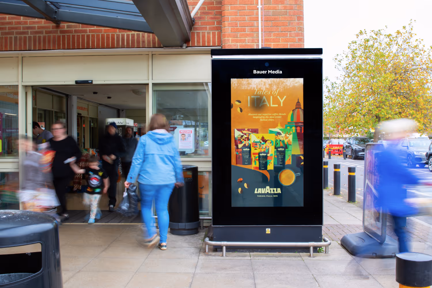 Advertising screen promoting Lavazza coffee at supermarket store entrance