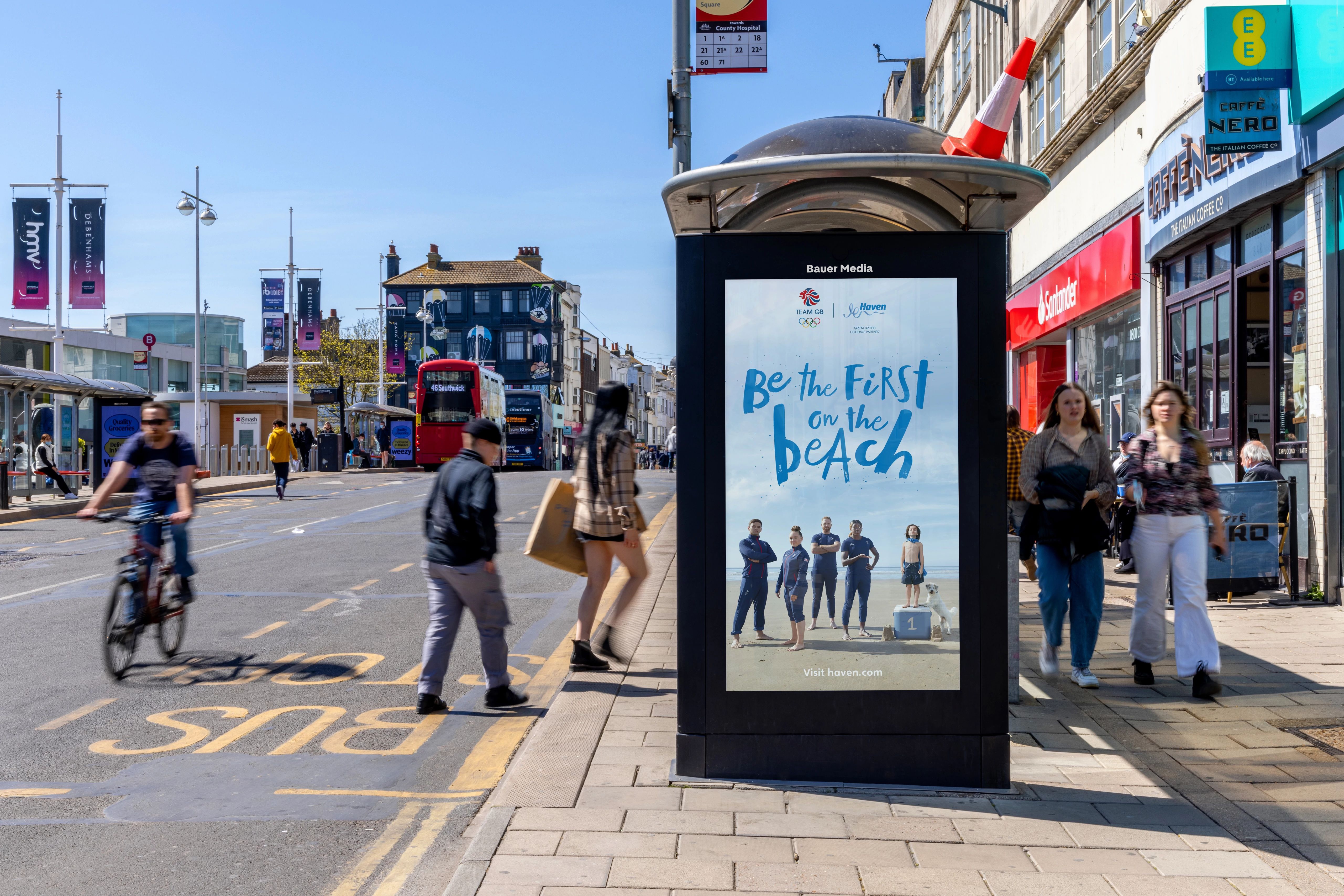 A digital bus stop screen on a sunny day