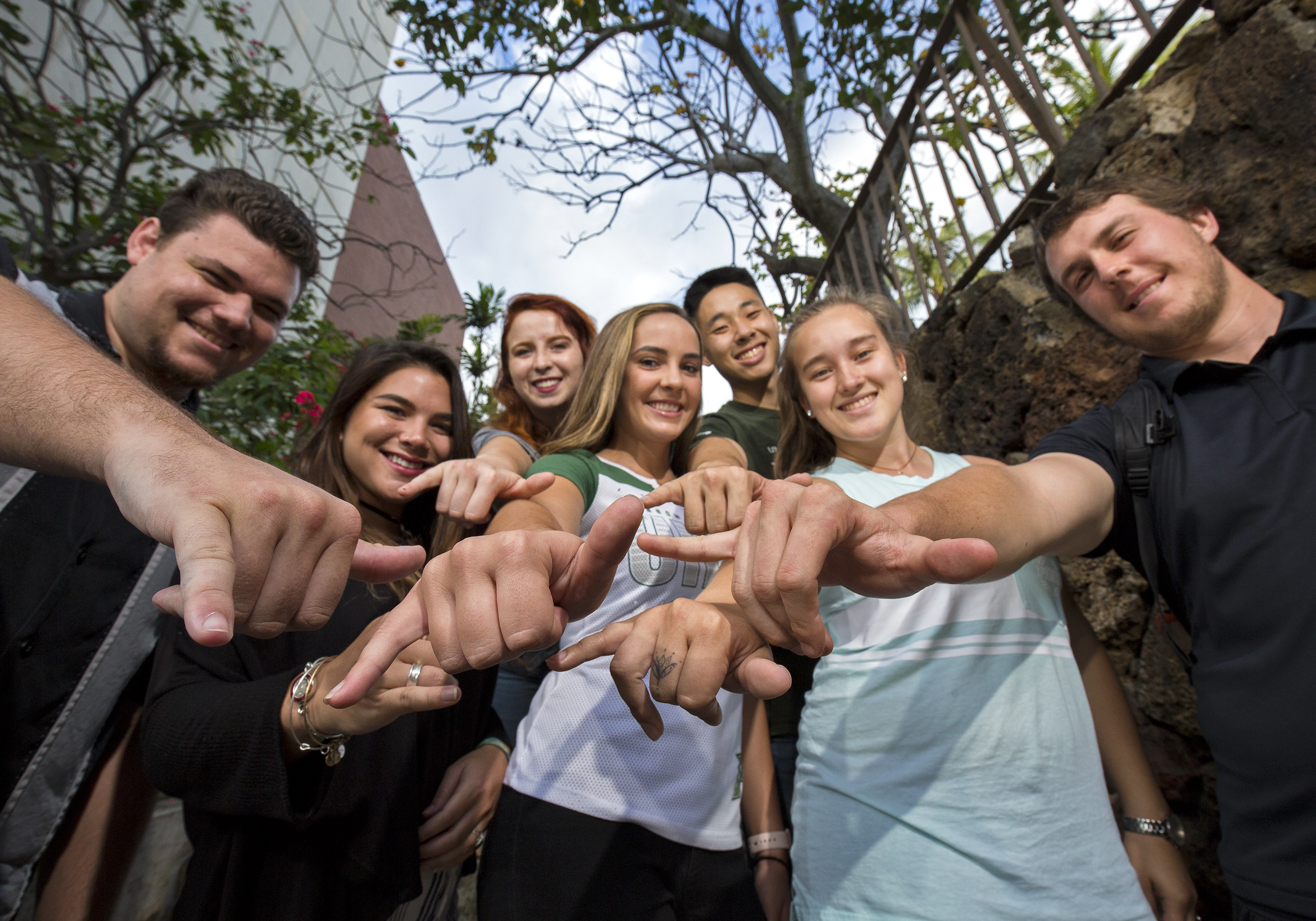 Students doing the shaka hand pose