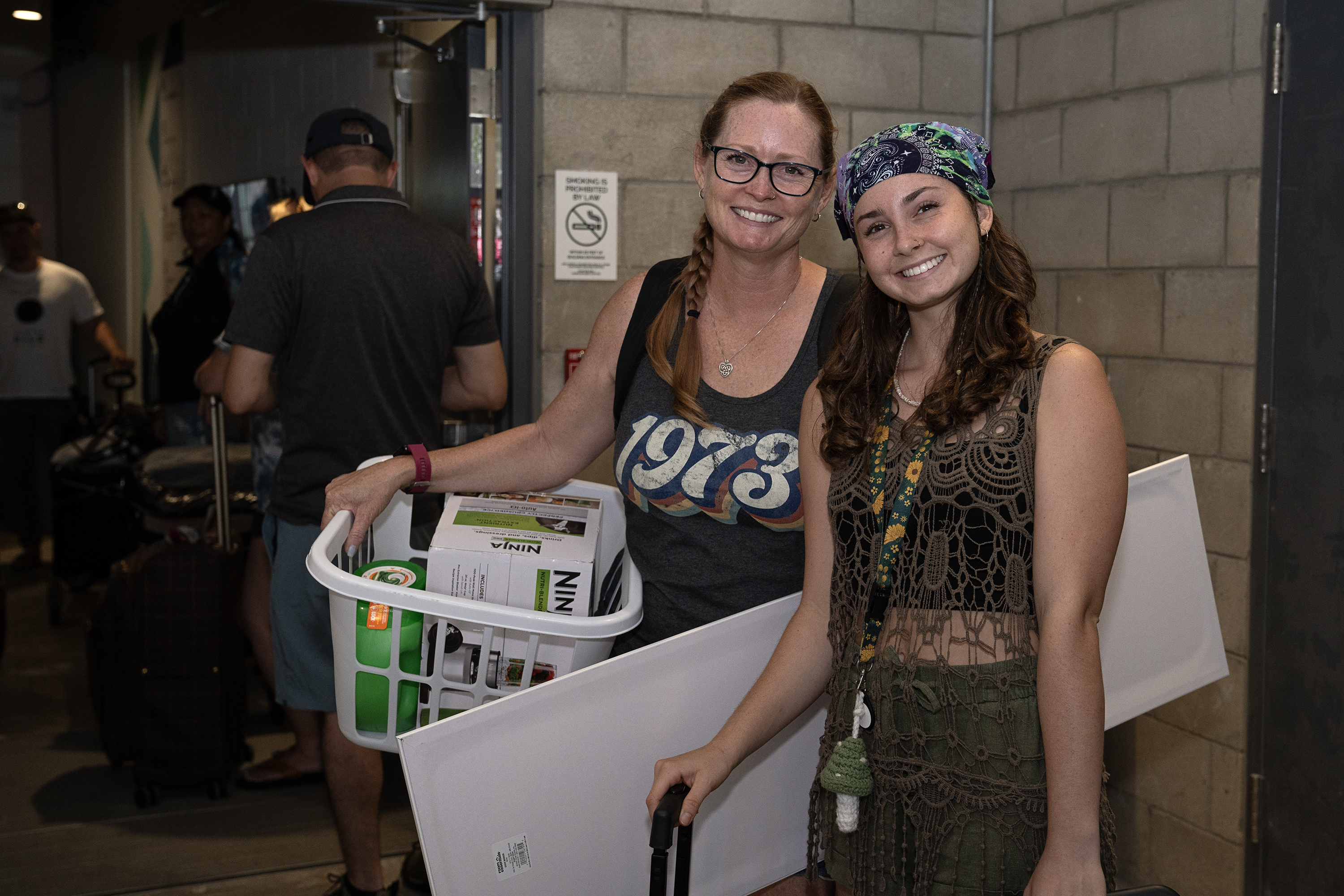 Students posing with laundry basket