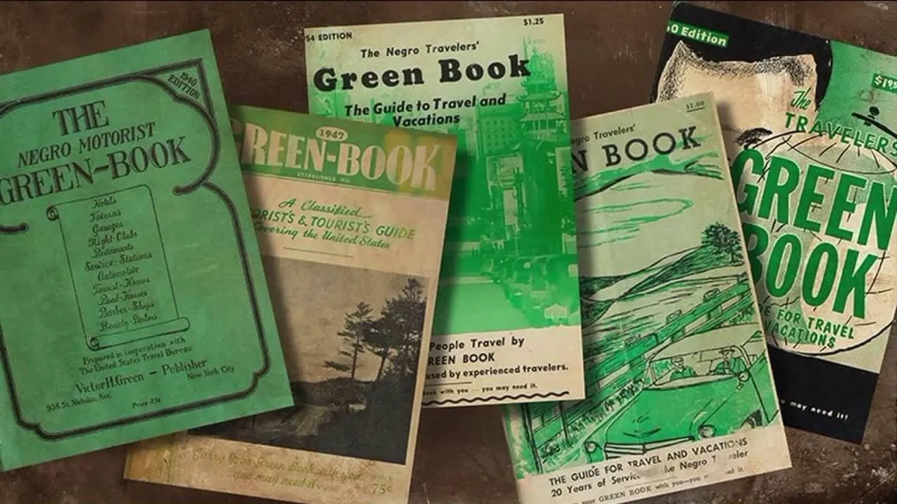 A collection of vintage Green Book travel guides for African American travelers, each with distinct green-themed covers.
