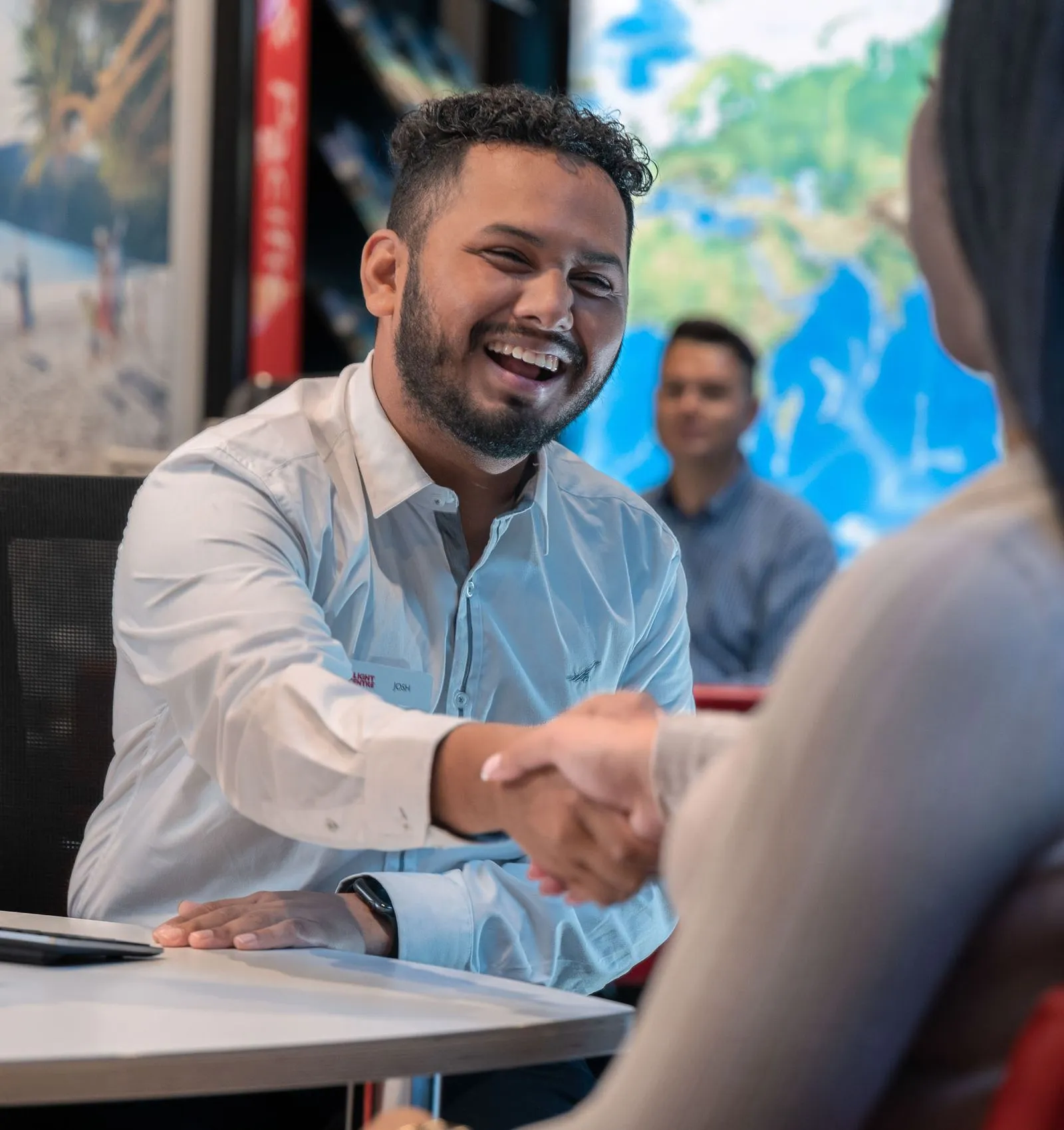 Engaging Flight Centre staff shaking hands and sharing smiles