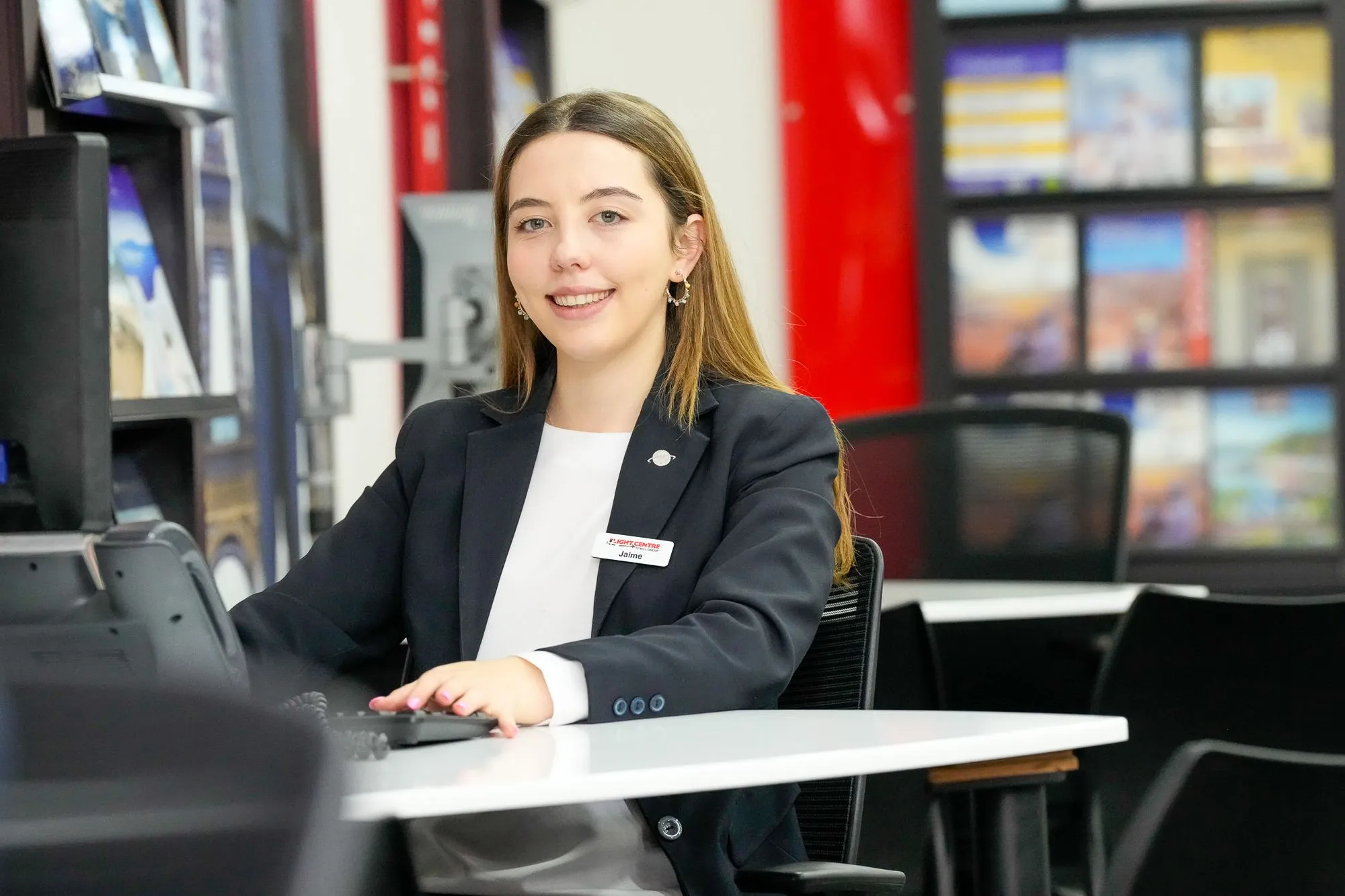 Professional Female Flight Centre staff members sitting at desk working