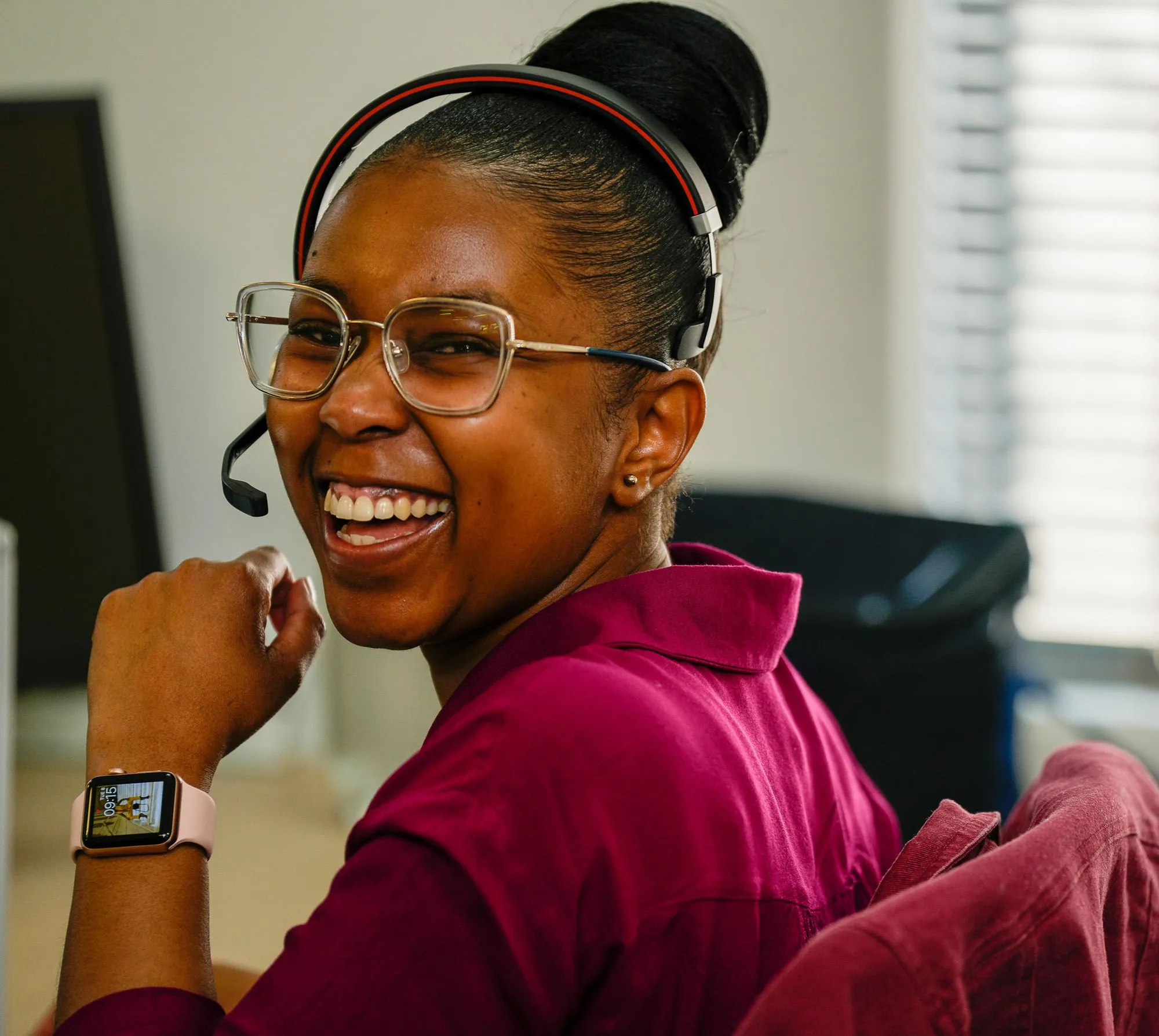 Helpful Flight Centre staff member turning around with headset and smiling