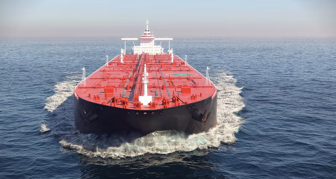Large red and black cargo ship moving forward through calm ocean waters.