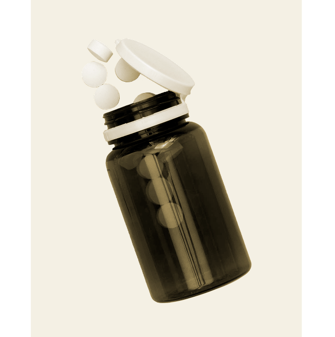 Opaque bottle with an open white cap spilling round white tablets on a light background.