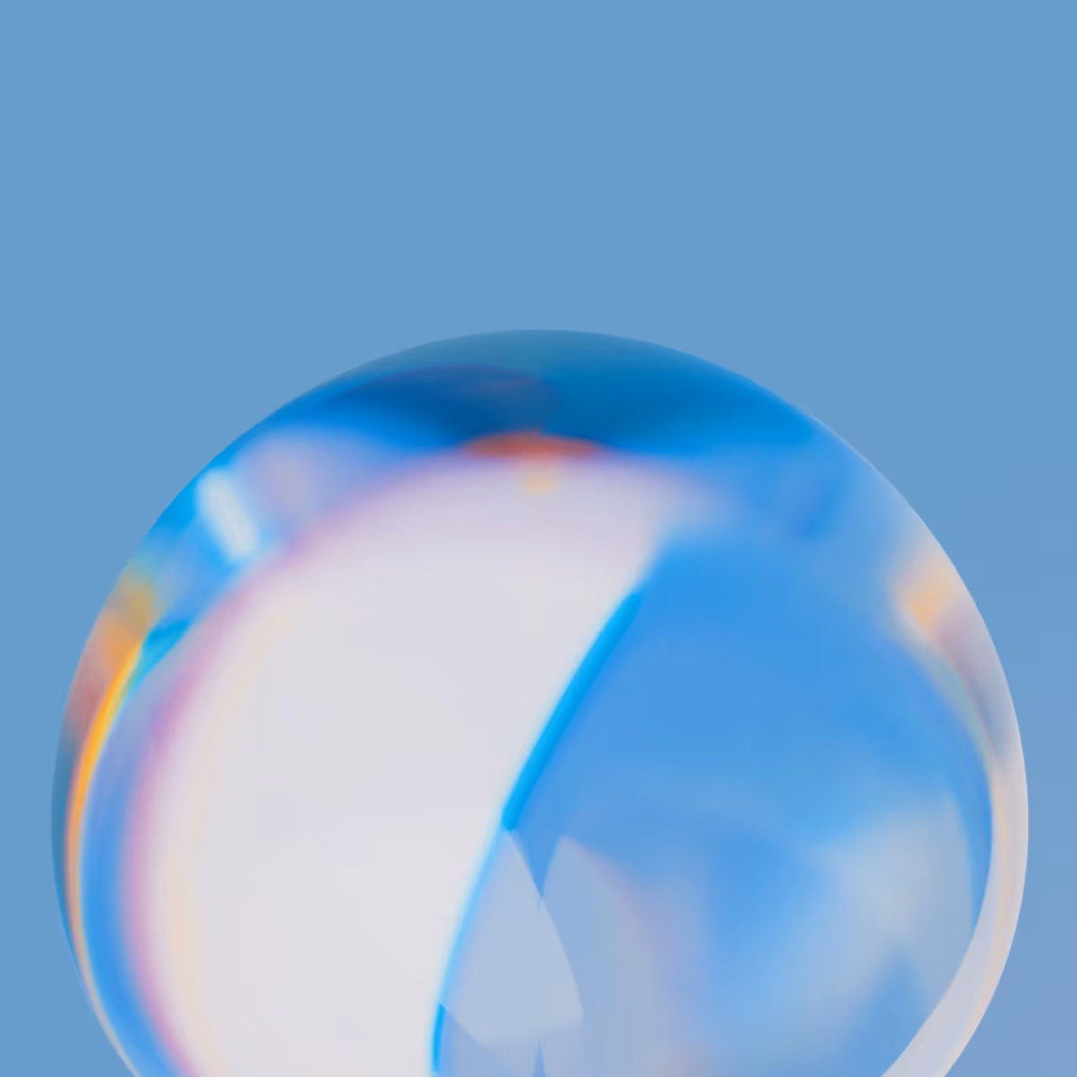 Close-up of a translucent, iridescent bubble against a blue background.