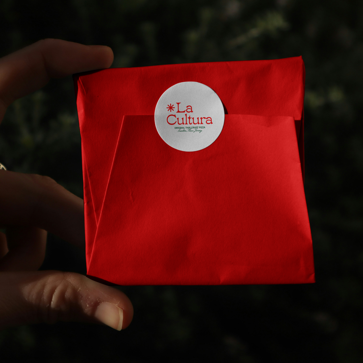 La Cultura sticker and wrapper in hand. 