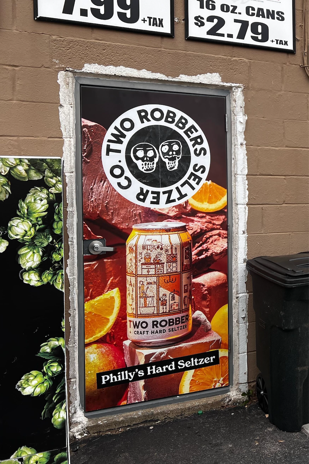 Two Robbers Orange Mango poster outside a liquor store.