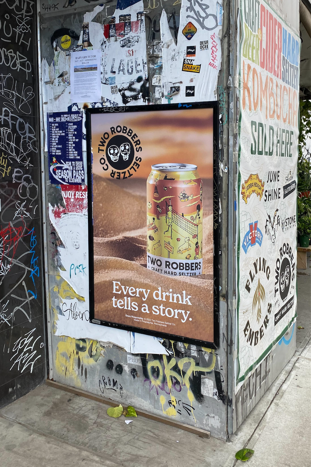 Two Robbers Grapefruit Kiwi poster outside a liquor store.