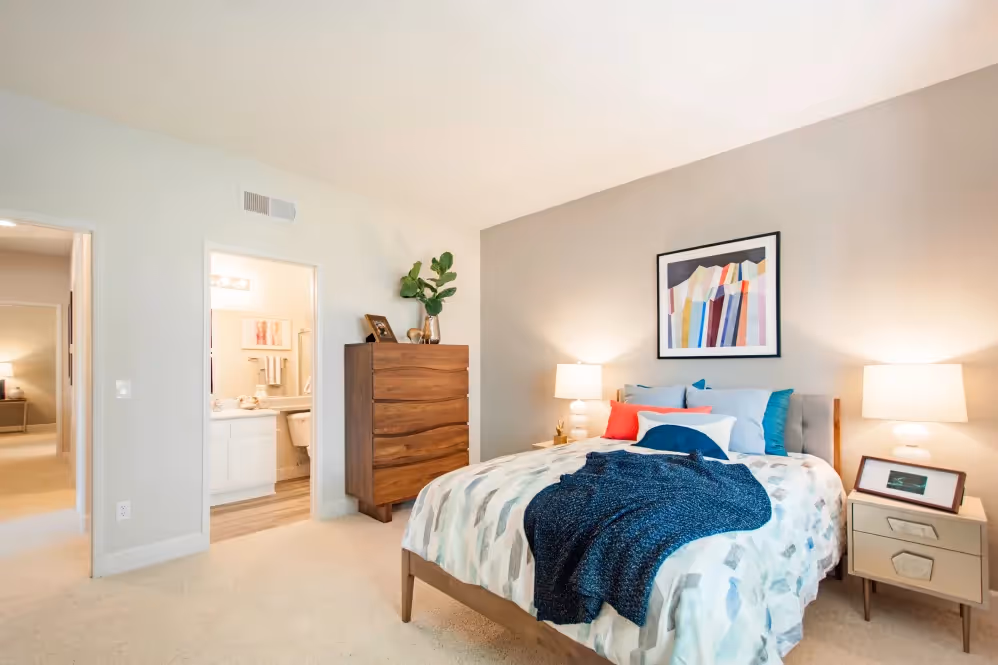 Furnished Bedroom with bed, wardrobe, and with a large window and view of hallway and bathroom