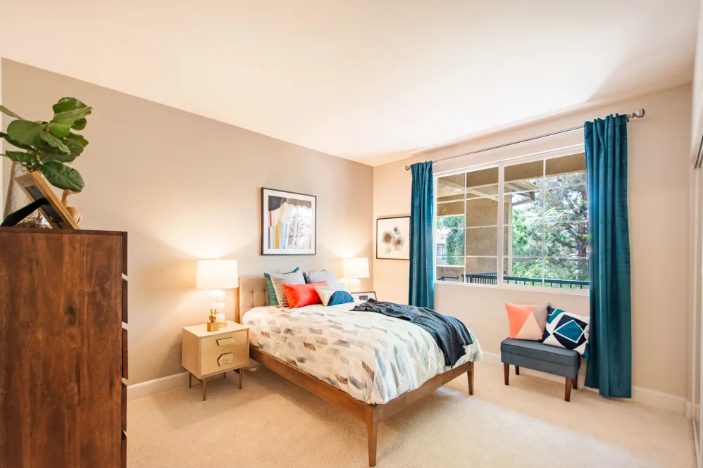 bedroom with bed, wardrobe and large window