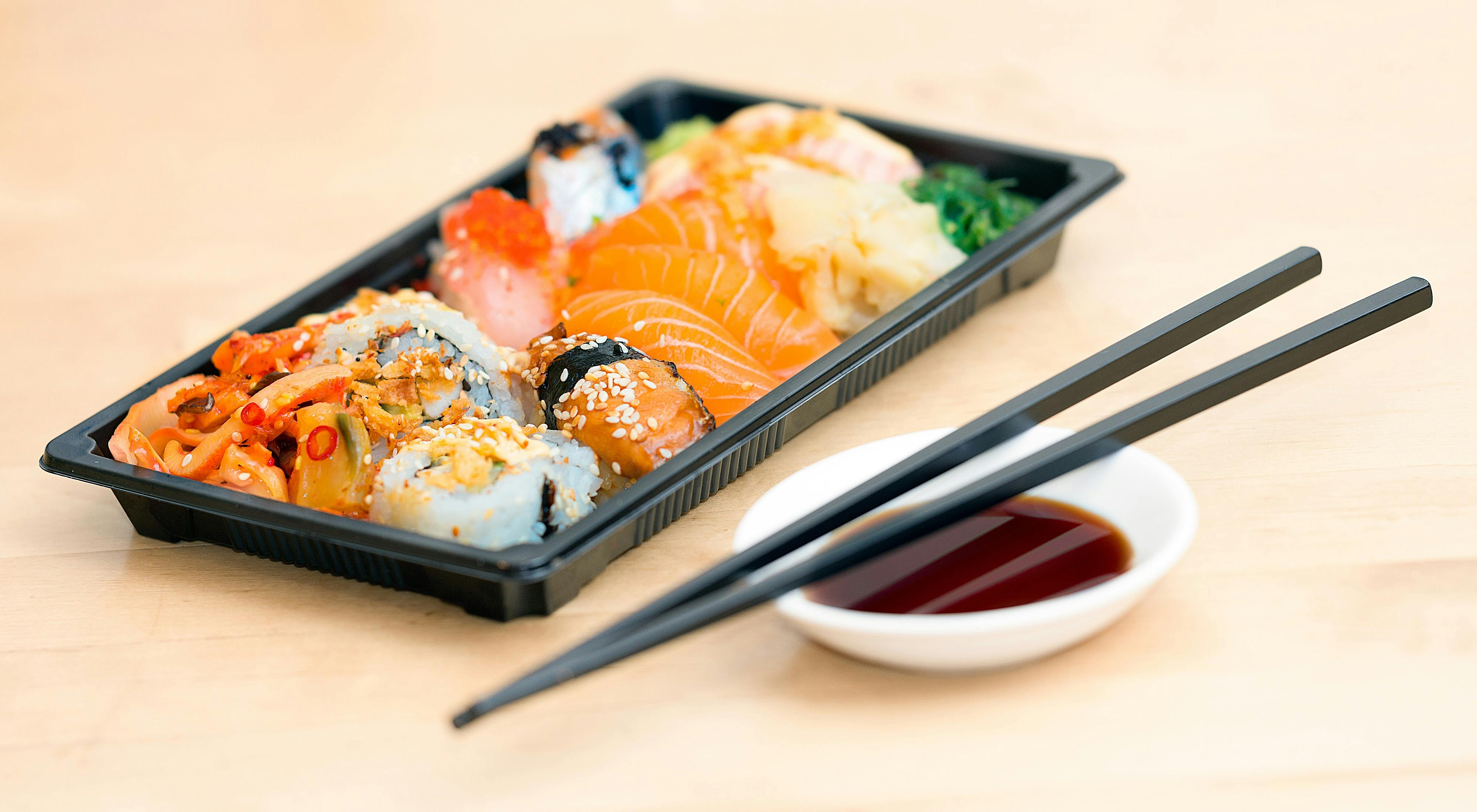 Tray of sushi with chopsticks and soy sauce stock image
