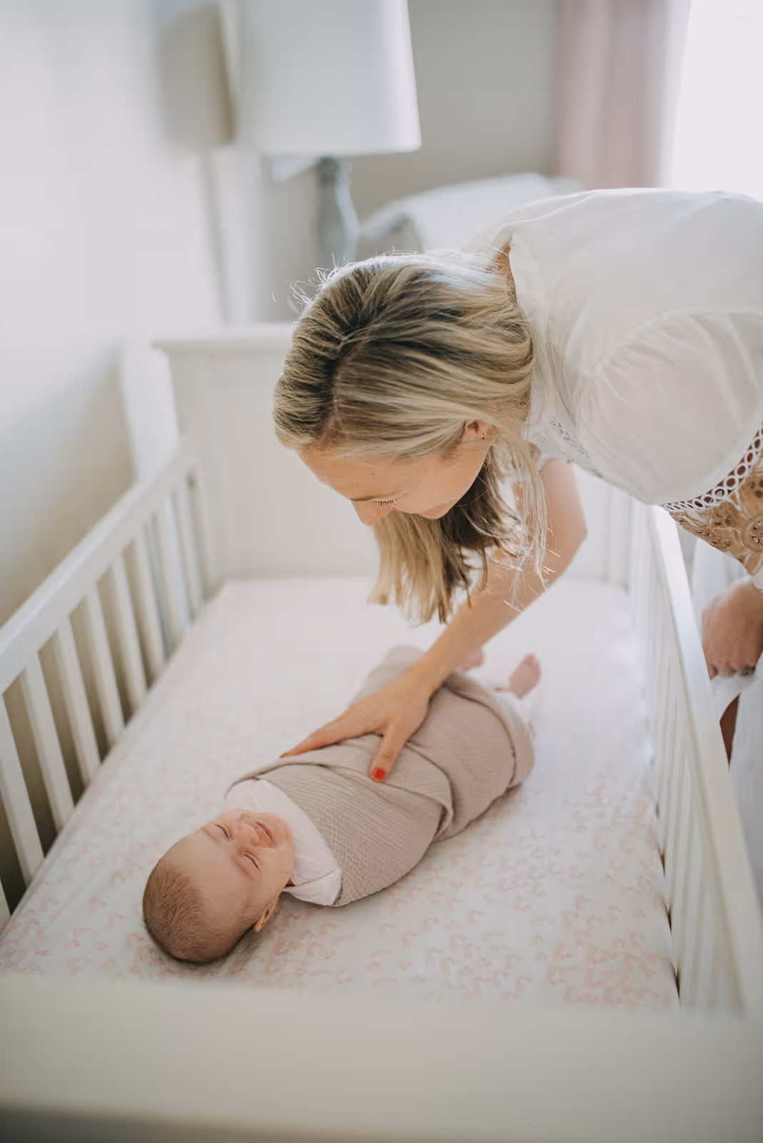 a woman standing next to a baby