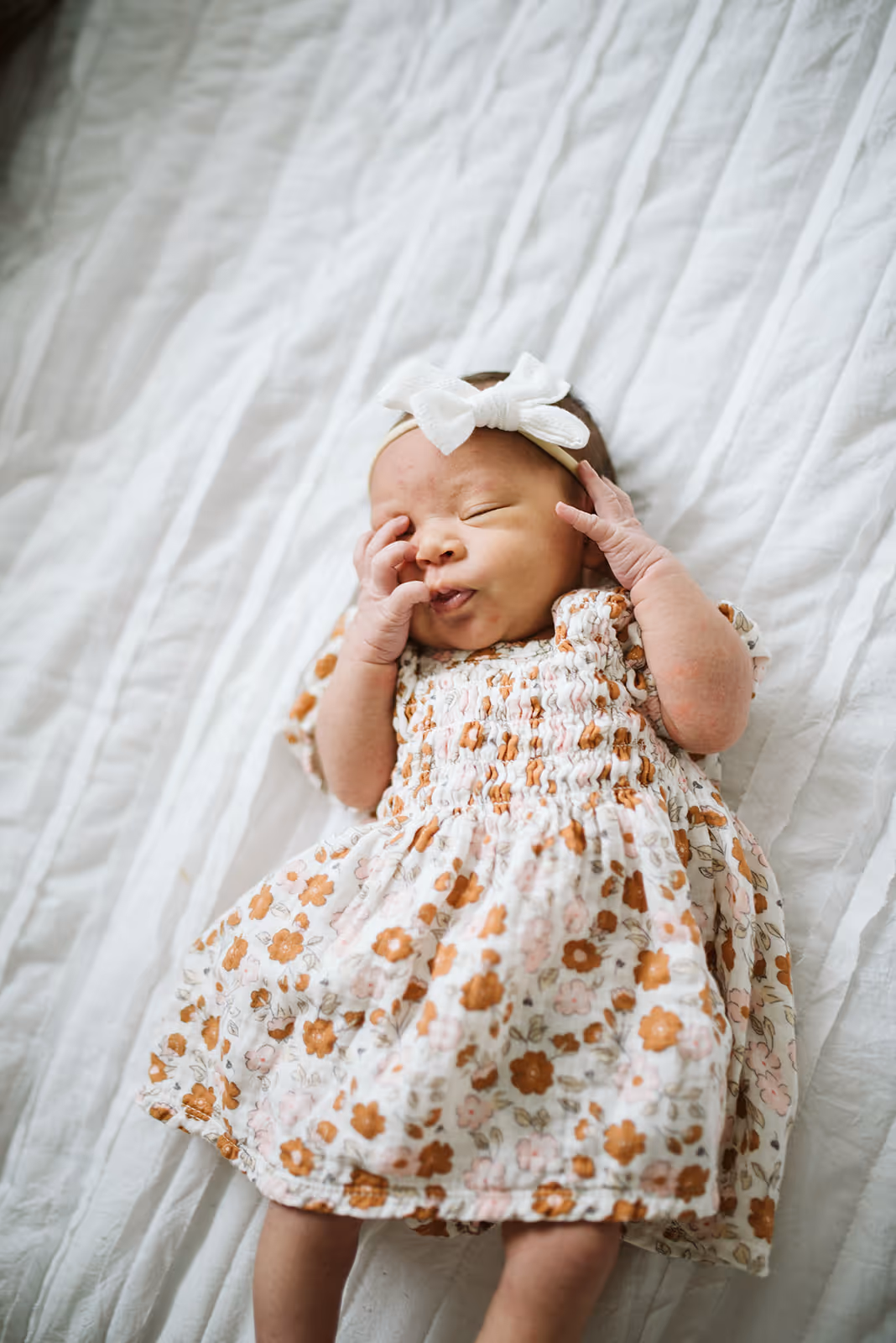 a baby lying on a blanket