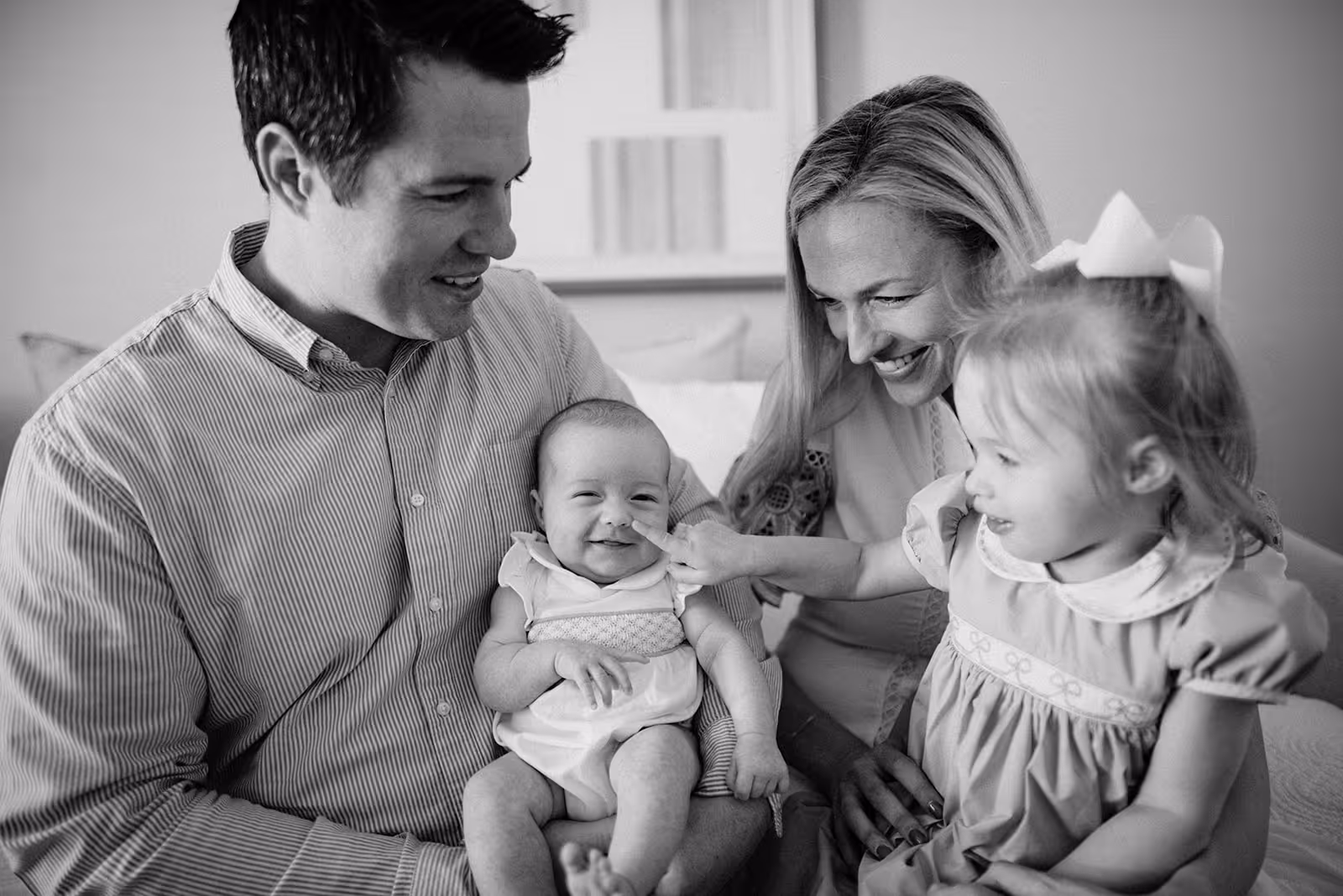 a man and woman holding a baby