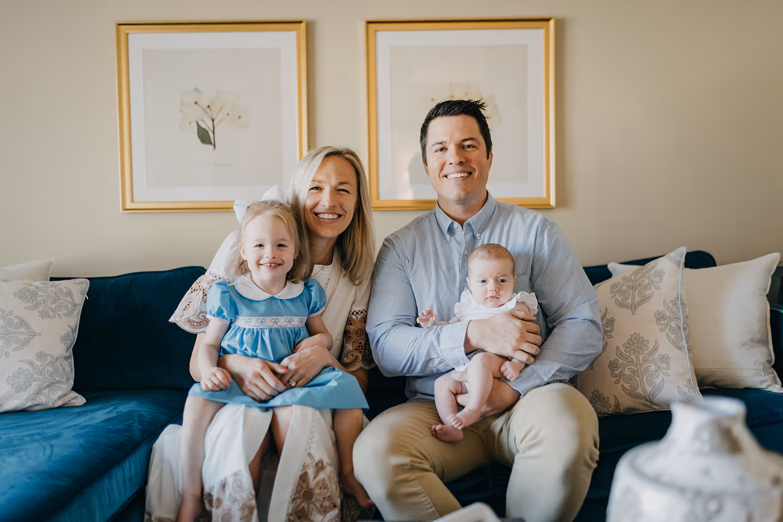 a man and woman sitting on a couch with two children
