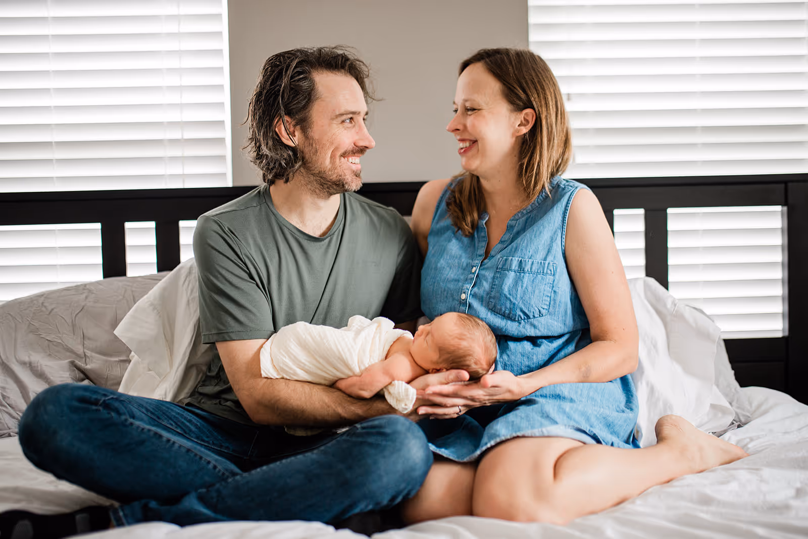 a man and woman holding a baby